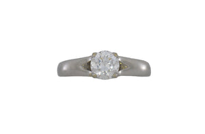 Silver ring with a diamond on a white background