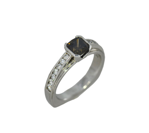 white gold ring with a central brown gemstone and smaller diamonds on a white background