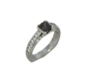 white gold ring with a central brown gemstone and smaller diamonds on a white background