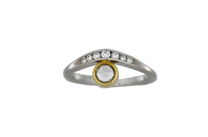 Ring with gold and white design on a white background
