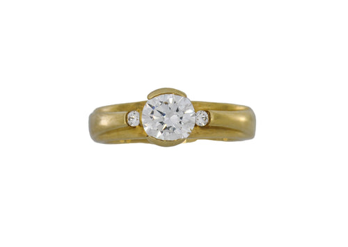 Gold ring with a diamond on a white background
