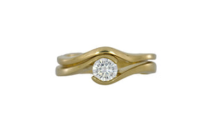 Gold ring with a diamond on a white background