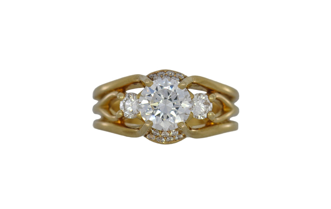 Gold ring with a diamond on a white background