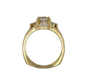 Gold ring with diamond accents on a white background