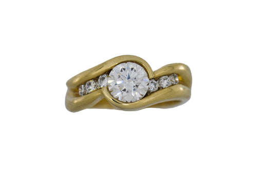 Gold ring with a large diamond and smaller diamonds on a white  background