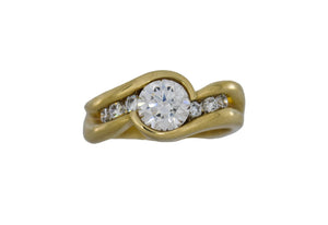 Gold ring with a large diamond and smaller diamonds on a white  background