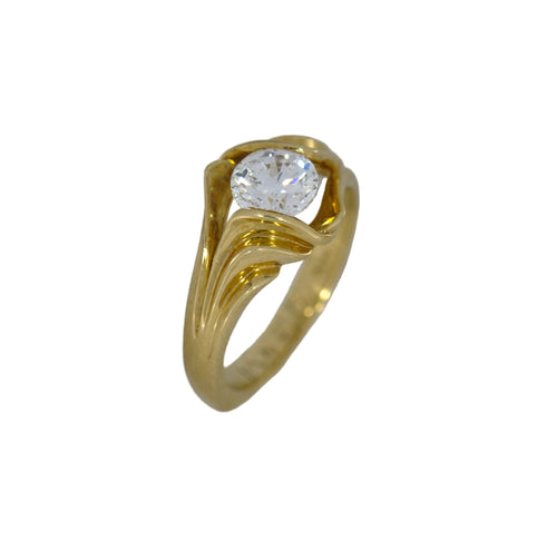 Gold ring with a round diamond on a white background