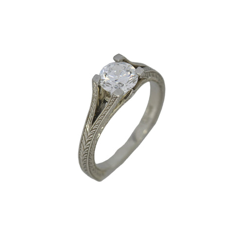 White gold ring with a diamond on a white background