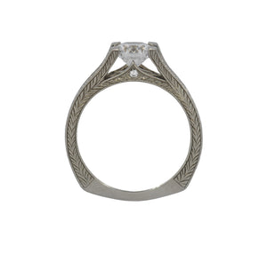 White gold ring with intricate design on a white background