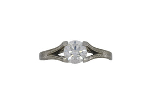 Diamond ring with white gold band on a white background