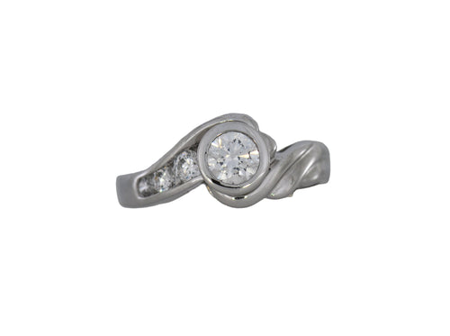 White gold ring with a central diamond and smaller diamonds on a white background