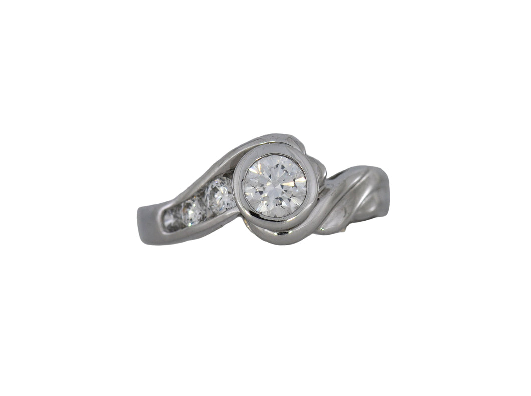 White gold ring with a central diamond and smaller diamonds on a white background
