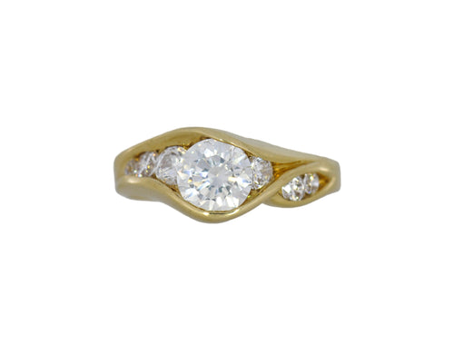 Gold ring with a diamond on a white background