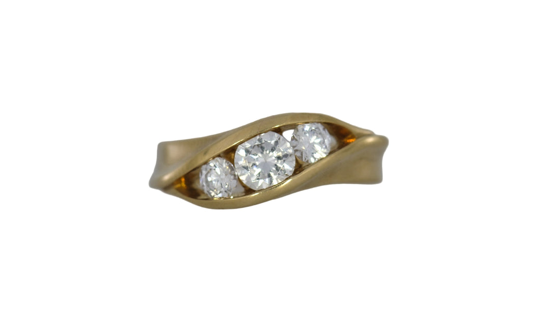 Gold ring with three diamonds on a white background