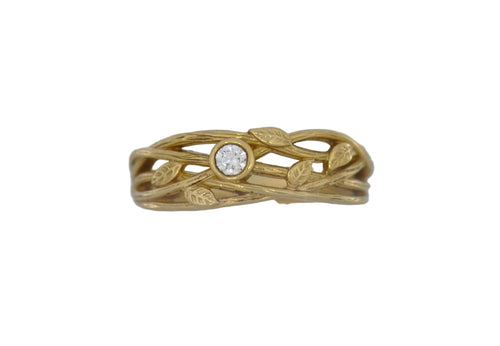 Gold ring with leaf design and diamond on a white background