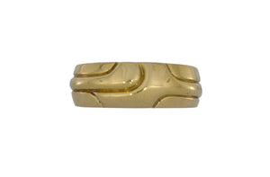 Gold ring with a reflective surface on a white background